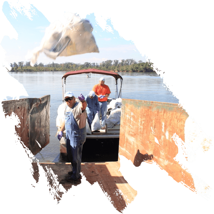 Volunteers collecting bagged garbage from lake