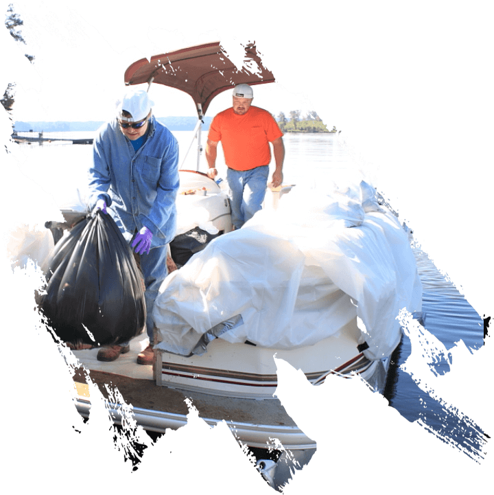 Volunteers unloading garbage from boat